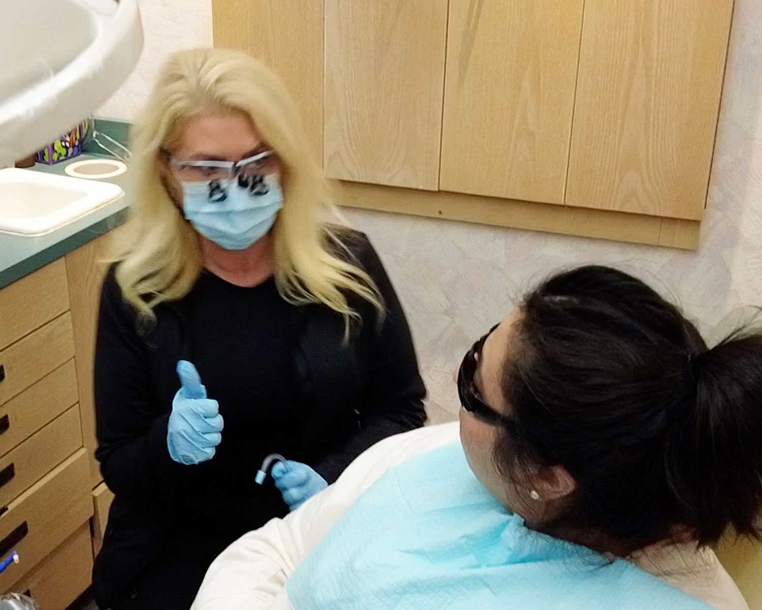 Dentist wearing mask and gloves giving thumbs up at Whittier Palm Dental in Montebello, CA