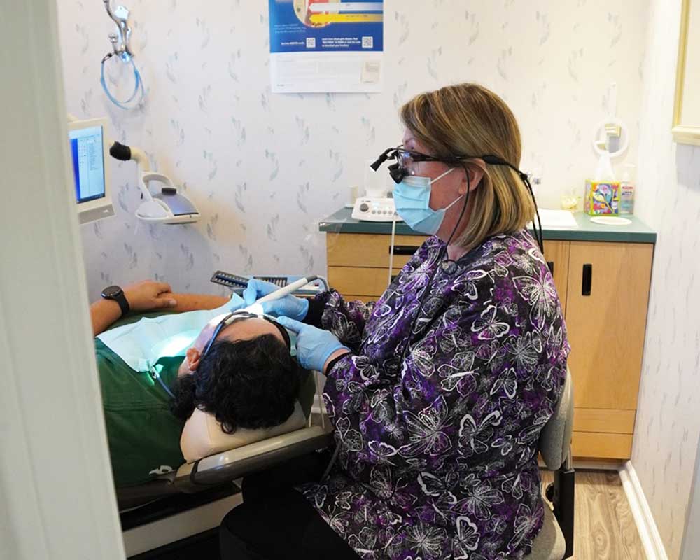 Dentist performing dental checkup at Whittier Palm Dental in Montebello, CA