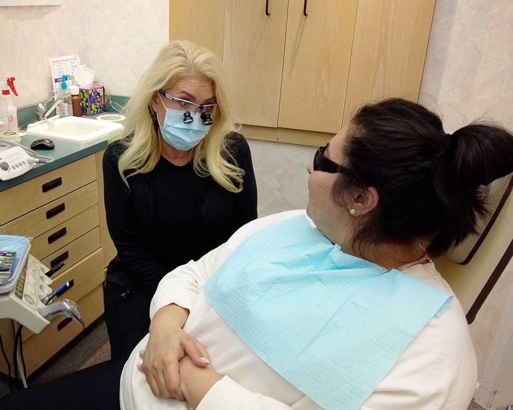 Dentist consulting patient at Whittier Palm Dental in Montebello, CA
