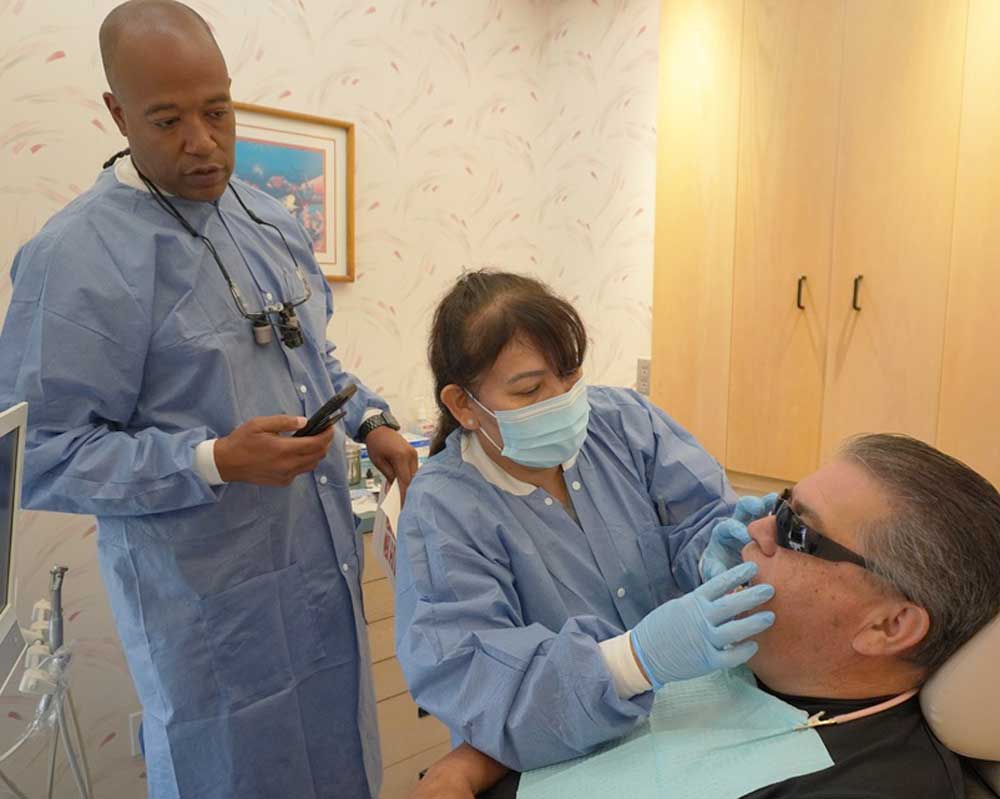 Dentist and assistant treating patient at Whittier Palm Dental in Montebello, CA